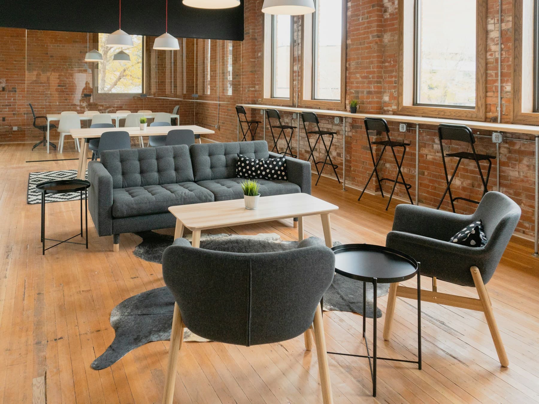 A bright room with a sofa, armchairs and a wooden coffee table